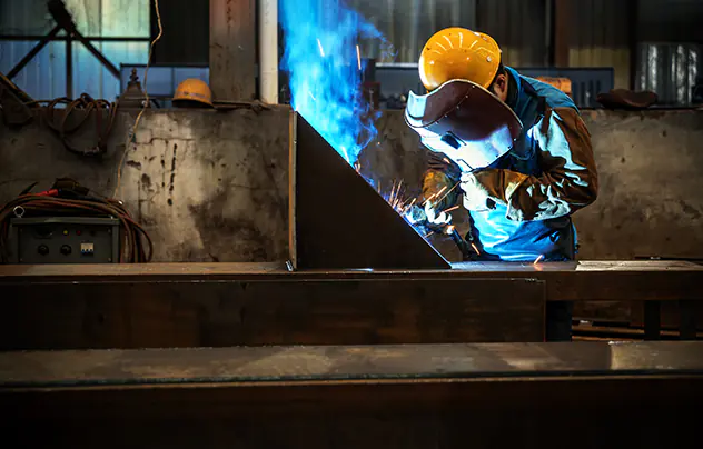 worker welding with mig-mag method