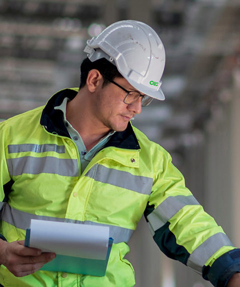 man on construction site in high-vis and hard hat