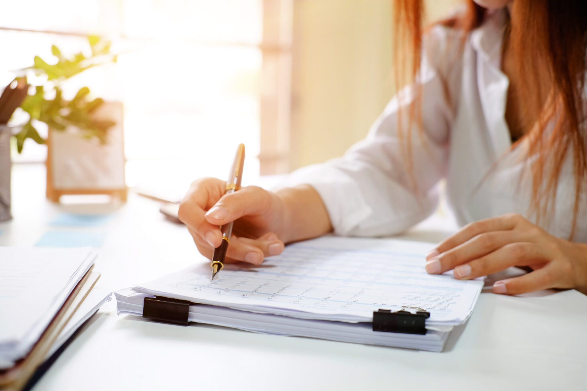 woman filling in forms at a desk