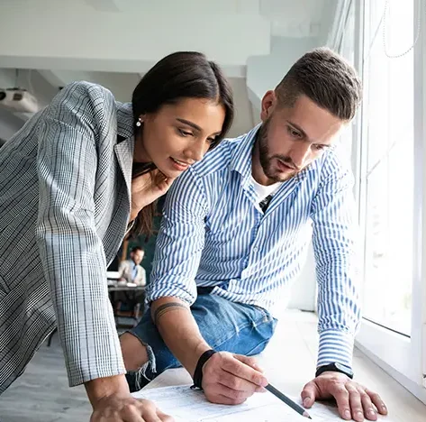 coworkers looking at pharmaceutical findings and discussing company benefits