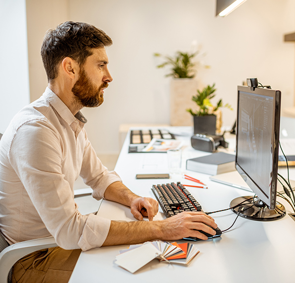 man working at a computer screen