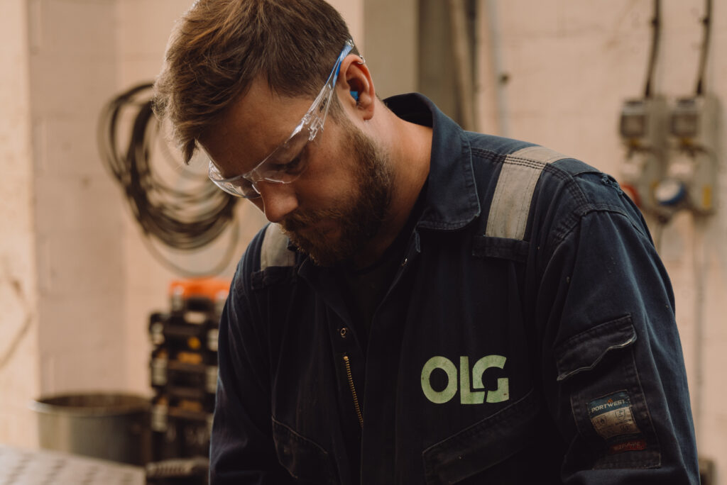 OLG engineer working and wearing protective glasses.