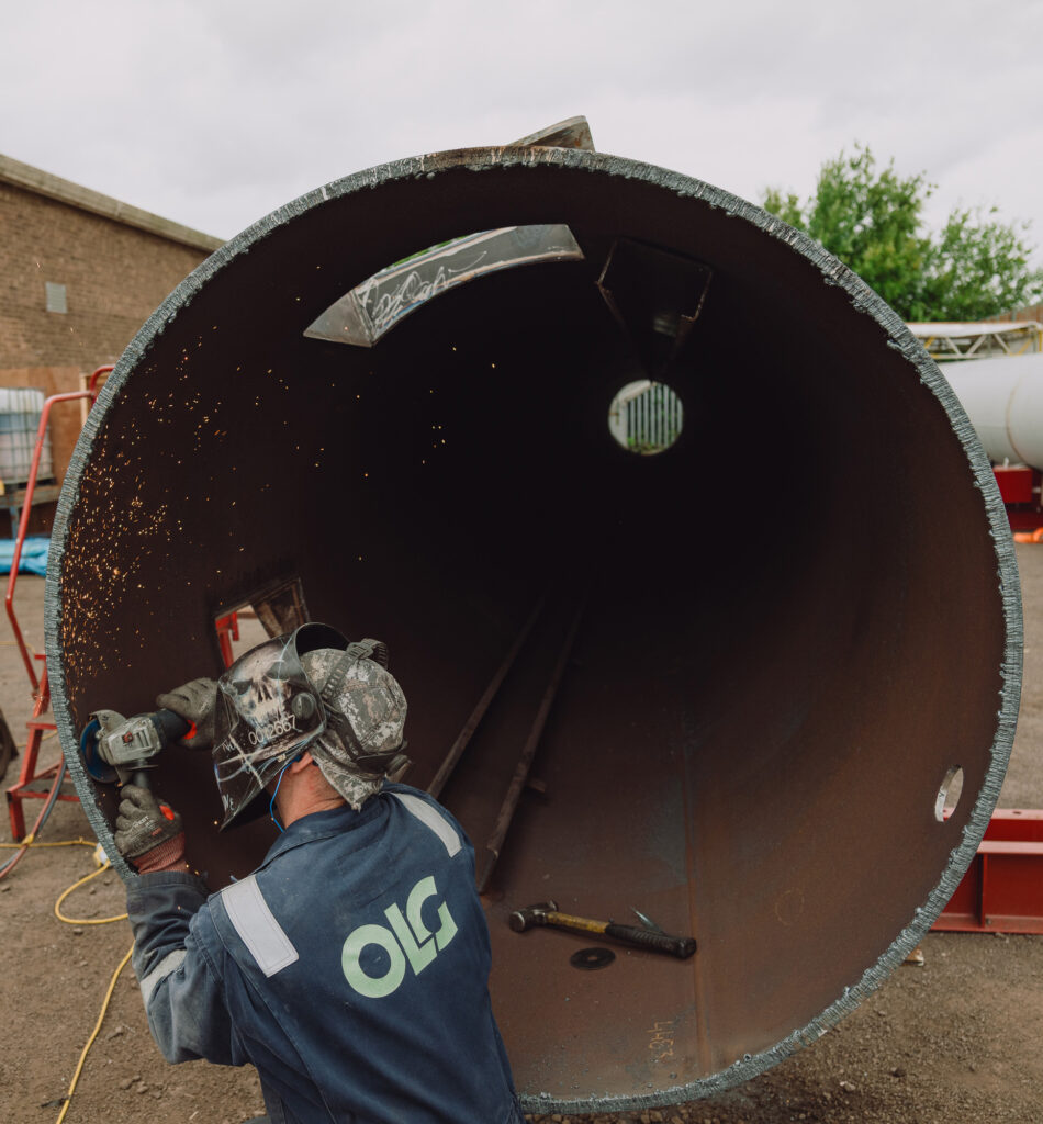 OLG engineer working on a fabrication project outside.