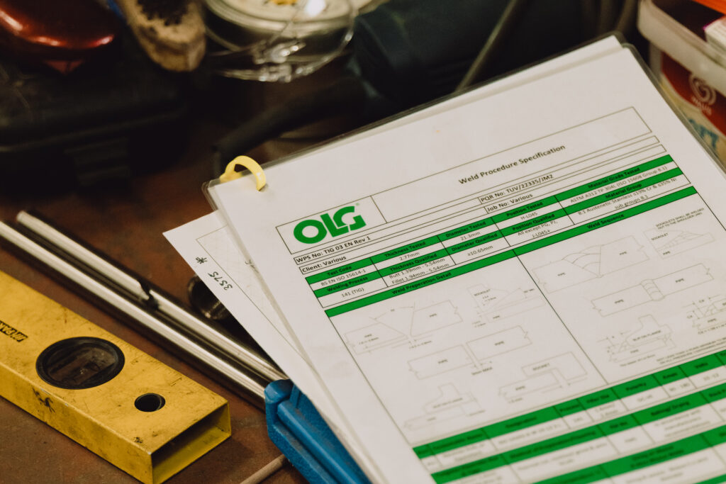Close up of OLG health and safety document on a workbench.